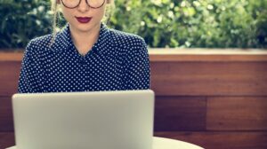 woman sitting alone using laptop concept PEJXY9T