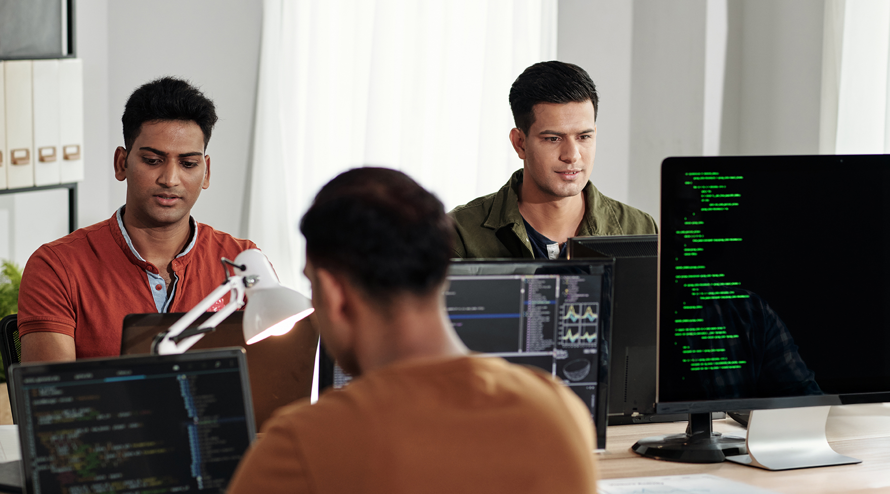 Group of engineers working a Devops help desk
