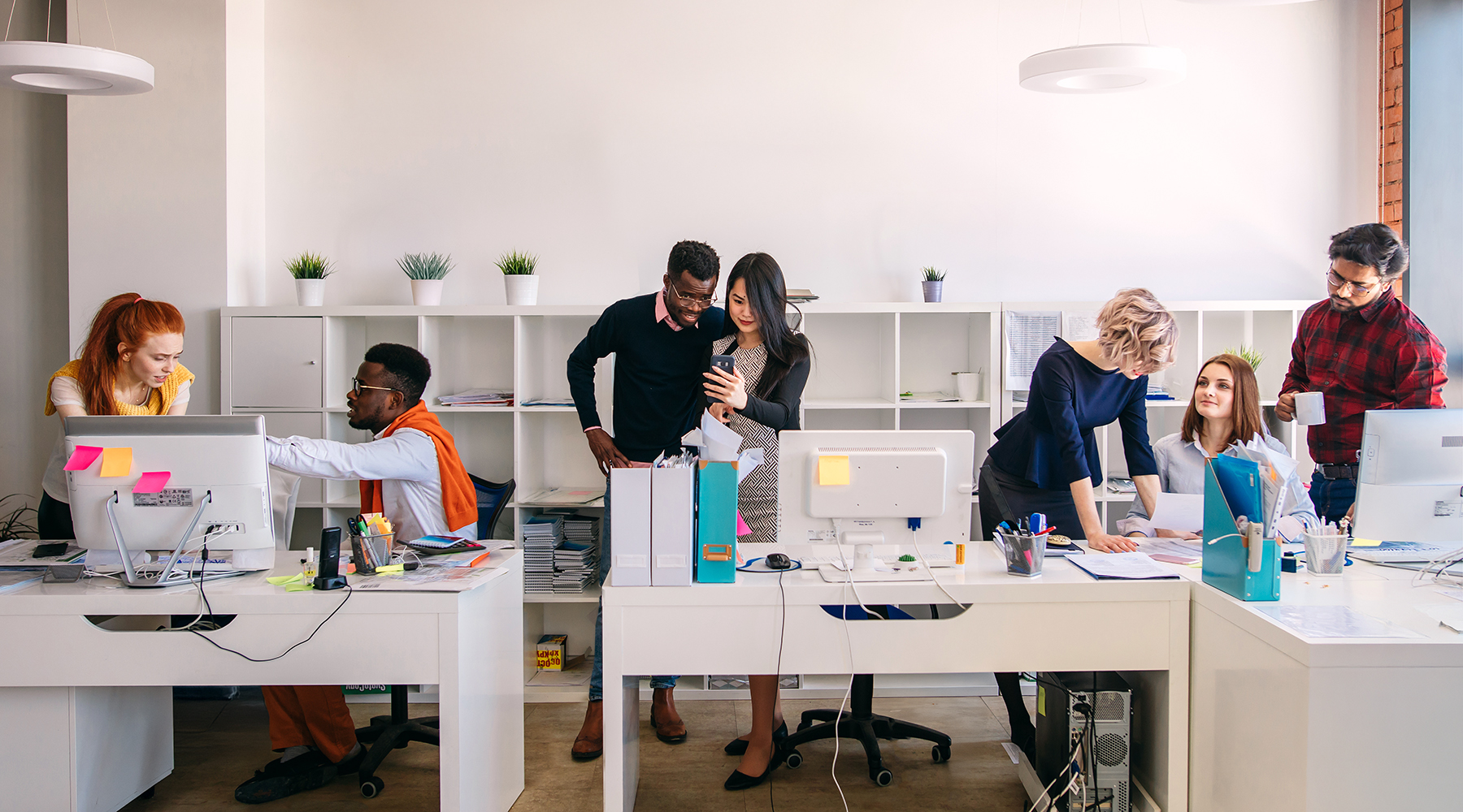 groups of people talking around office desks